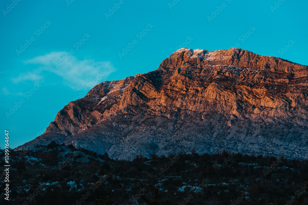 Fototapeta premium Golden Hour View of Majestic Mountain in Southern Croatia with Snow-Capped Peaks