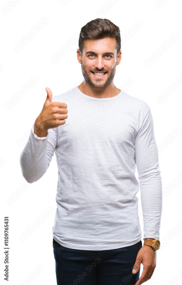 Young handsome man over isolated background doing happy thumbs up gesture with hand. Approving expression looking at the camera with showing success. Young handsome man over isolated background doing happy thumbs up gesture with hand. Approving expression looking at the camera with showing success.