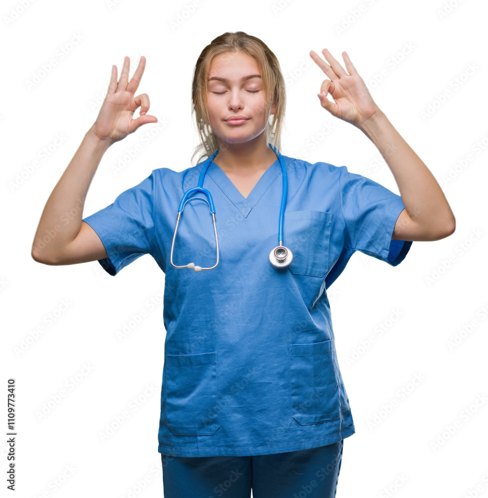 Young caucasian doctor woman wearing surgeon uniform over isolated background relax and smiling with eyes closed doing meditation gesture with fingers. Yoga concept. Young caucasian doctor woman wearing surgeon uniform over isolated background relax and smiling with eyes closed doing meditation gesture with fingers. Yoga concept.