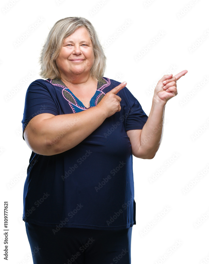 Obraz premium Senior plus size caucasian woman over isolated background smiling and looking at the camera pointing with two hands and fingers to the side.