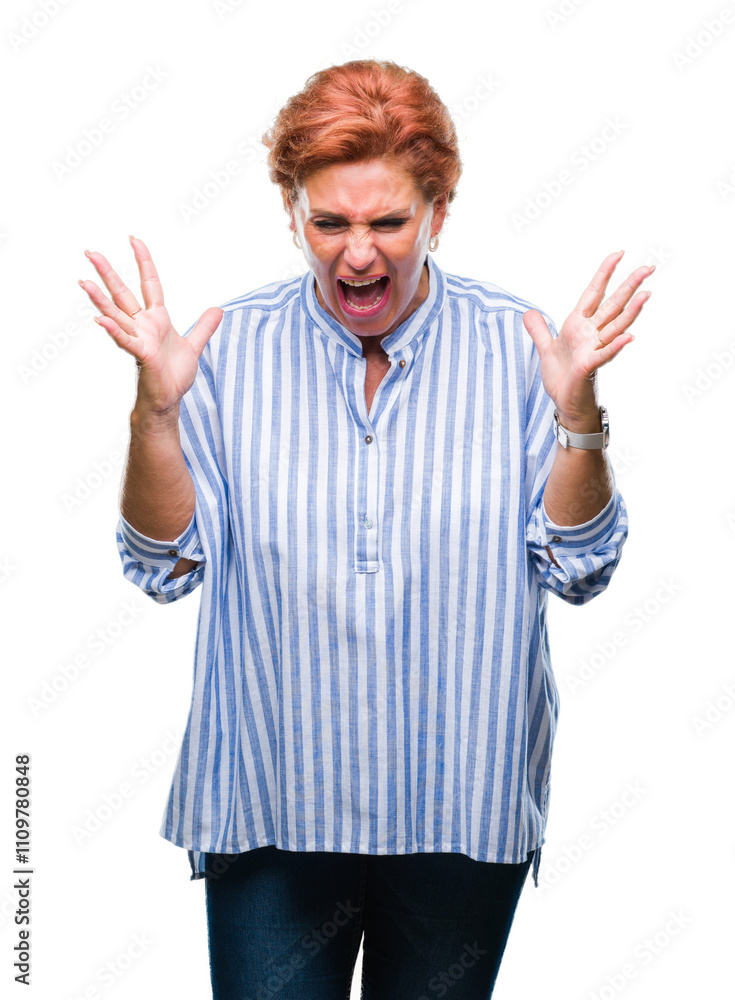 Atrractive senior caucasian redhead woman over isolated background celebrating mad and crazy for success with arms raised and closed eyes screaming excited. Winner concept Atrractive senior caucasian redhead woman over isolated background celebrating mad and crazy for success with arms raised and closed eyes screaming excited. Winner concept