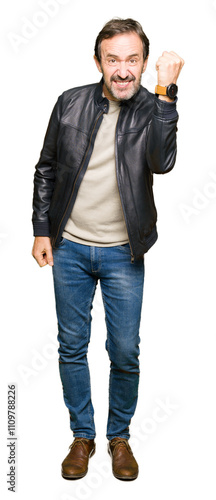 Middle age handsome man wearing black leather jacket angry and mad raising fist frustrated and furious while shouting with anger. Rage and aggressive concept.