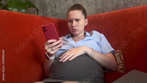 pregnant upset and nervous woman using phone