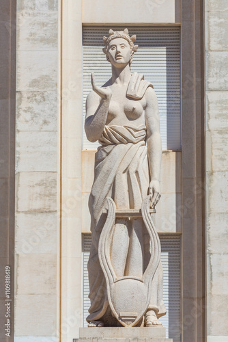 Canvas-taulu A detailed view of a statue of a woman, possibly a muse or a goddess, holding a