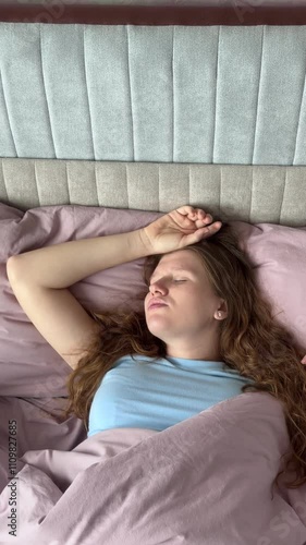 beautiful young woman snoring in her sleep in bed, concept apnea, snoring, disorder