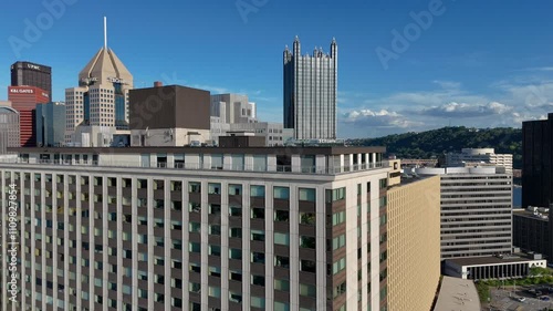 Capture the urban landscape of Pittsburgh with this exhilarating aerial drone footage. The clip showcases a flight across the downtown skyline, while navigating closely around towering buildings.
