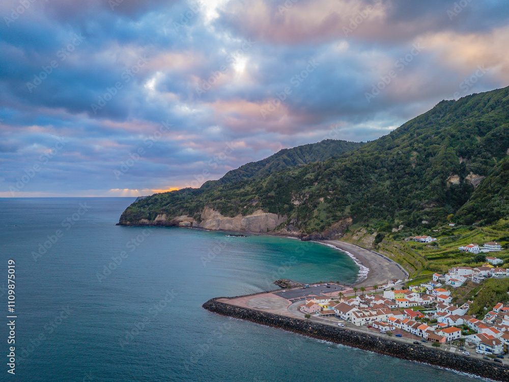 Fototapeta premium Aerial drone view of Ribeira Quente and Praia do Fogo with volcanic black sand beach. Landscape of Sao Miguel coastline with green mountains in Azores