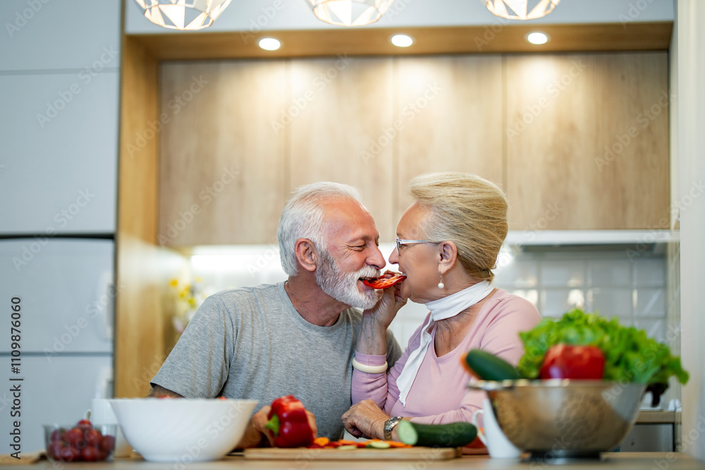 Happy Senior Couple Sharing a Romantic Moment in Kitchen Happy Senior Couple Sharing a Romantic Moment in Kitchen