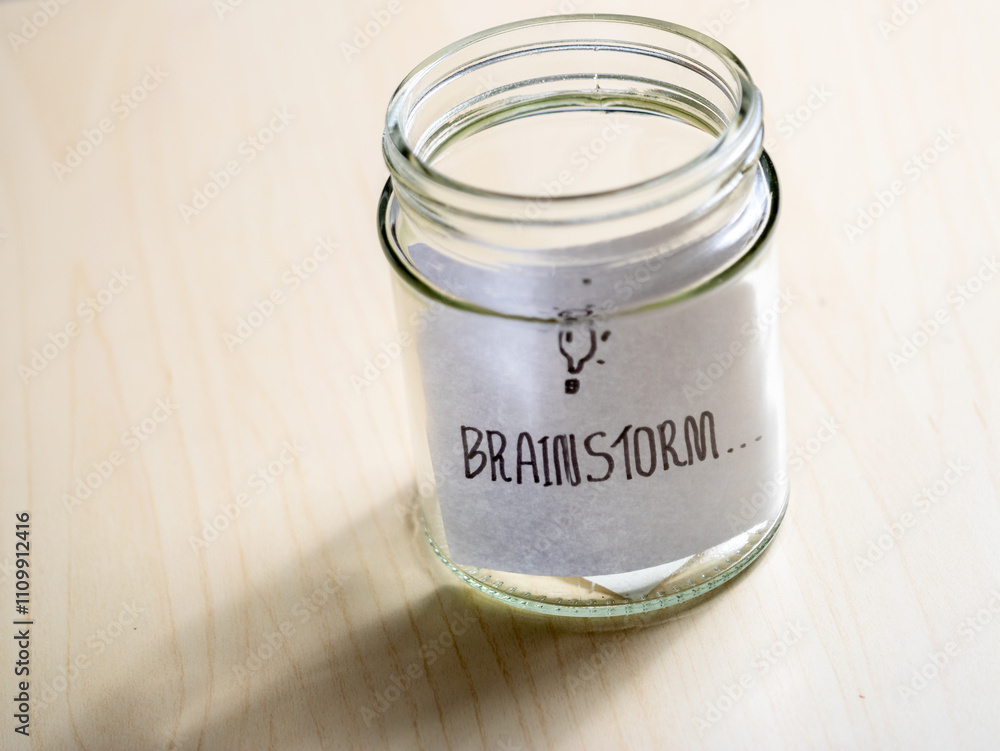 Close-up view of a glass jar in a minimalist home office brainstorming session