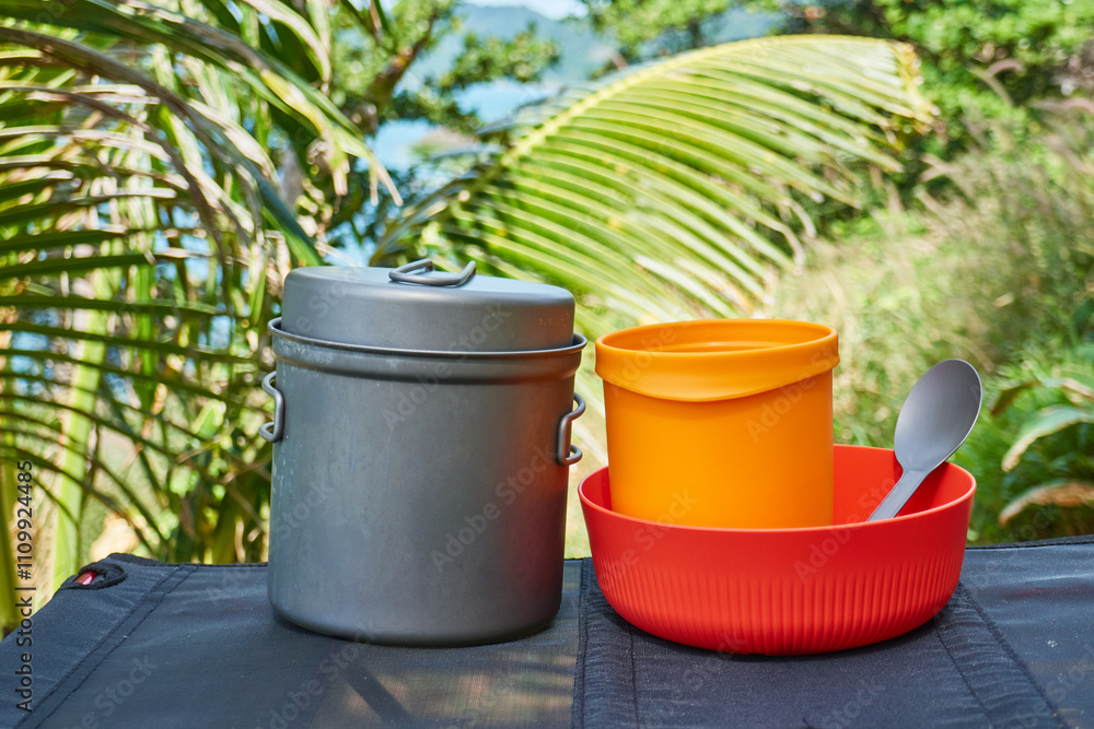 ultralight kitchen set for traveling on a folding table, in nature with a tropical view ultralight kitchen set for traveling on a folding table, in nature with a tropical view