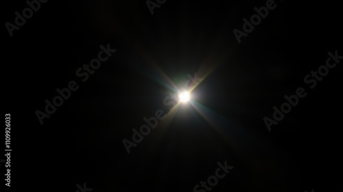 A Brilliant Starburst of Light Radiates from a Single Point in the Center of a Dark Background photo