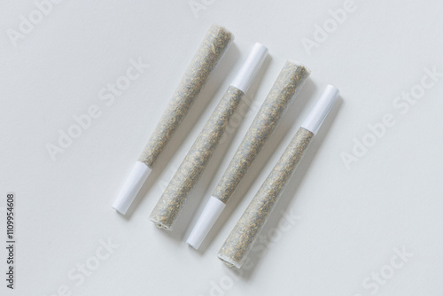 Clean overhead photo of Four Marijuana Joints on white background