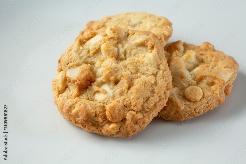 A view of a white chocolate chip macadamia nut cookie. A view of a white chocolate chip macadamia nut cookie.