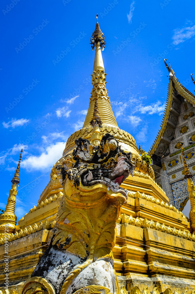 Fototapeta premium Chapel and Gold Pagoda, Lanna Architecture, Symbols of Buddhism, South East Asia at Ko Klang temple, Muang Chiang Mai, Chiang Mai, Northern Thailand