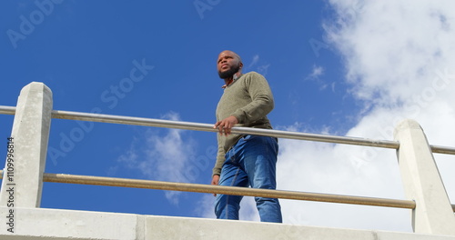 Wallpaper Mural Low angle view of man standing near railings Torontodigital.ca