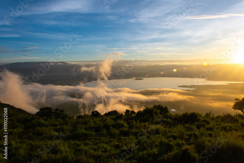 Sunrise with clouds coming over the rim of the crater