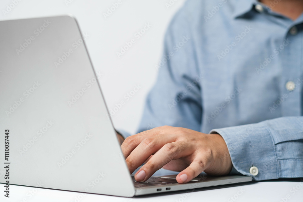 A person typing on a laptop, showcasing modern technology in a professional setting. A person typing on a laptop, showcasing modern technology in a professional setting.