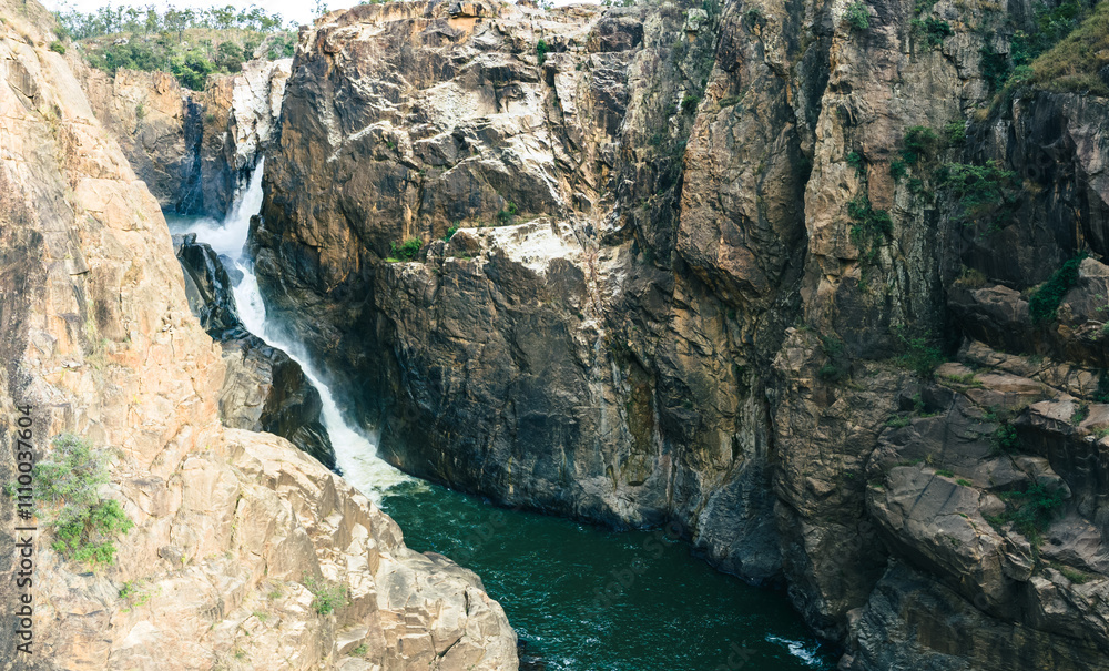 Waterfall over the side of a gorge into the Herbert River Waterfall over the side of a gorge into the Herbert River