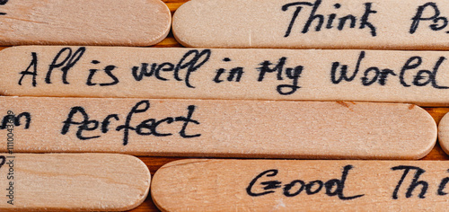 Canvas Print Positive thoughts for increasing selfesteem on wooden posts on wooden background