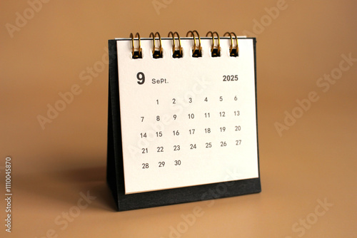 Monthly calendar template for the new year 2025 desk calendar,isolated on Beige background. photo