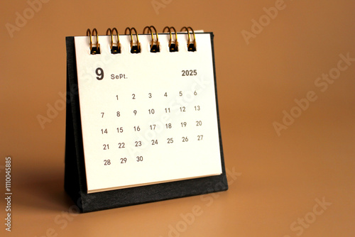 Monthly calendar template for the new year 2025 desk calendar,isolated on Beige background. photo