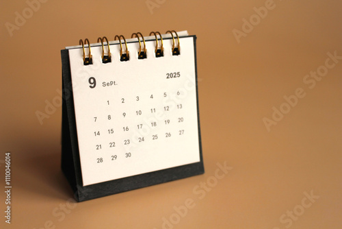 Monthly calendar template for the new year 2025 desk calendar,isolated on Beige background. photo