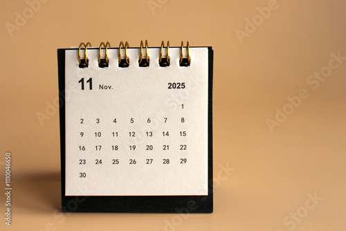 Monthly calendar template for the new year 2025 desk calendar,isolated on Beige background. photo