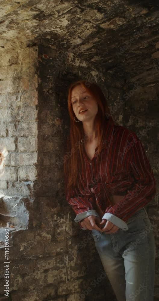 Two women are smiling and talking standing near a window in a historic abandoned building. A sunny summer day Two women are smiling and talking standing near a window in a historic abandoned building. A sunny summer day