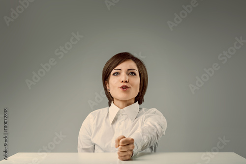 Young businesswoman showing dominance at office desk