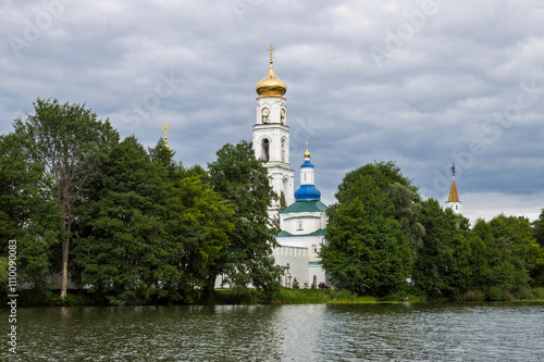 Raifa Bogoroditsky Monastery, Raifa, Republic of Tatarstan, Russia. View from Lake Raifa to the high bell tower behind the monastery wall. An ancient Orthodox monastery. photo