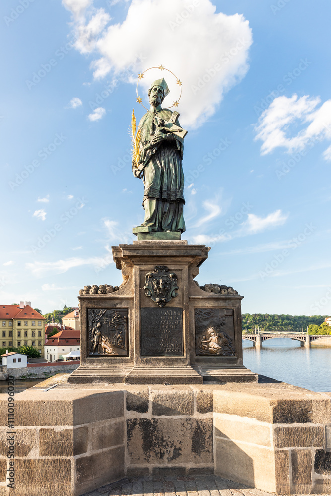 Fototapeta premium Sculpture of St John of Nepomuk by Ian Brokoff on the Charles Bridge in Prague in the Czech Republic