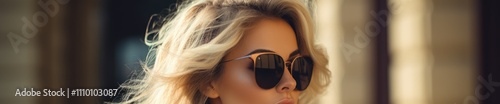 Stylish Woman with Wavy Blonde Hair Wearing Sunglasses Outdoors on a Sunny Day photo