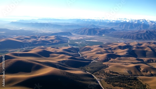 Aerial View of Rolling Hills Mountains and Valley Landscape. Roads wind through the landscape.