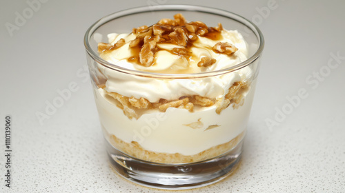 Creamy Greek yogurt parfait with honey and walnuts in glass