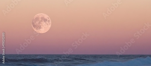 Fototapeta Naklejka Na Ścianę i Meble -  Serene full moon illuminating the evening sea horizon with pastel sunset colors reflecting on tranquil waters