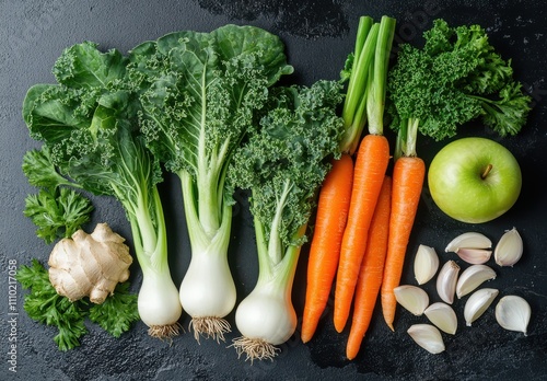 Fresh Organic Vegetables on Black Background: Ginger, Garlic, Kale, Carrots, Green Apple, and Fresh Herbs for Healthy Culinary Recipes and Nutrition