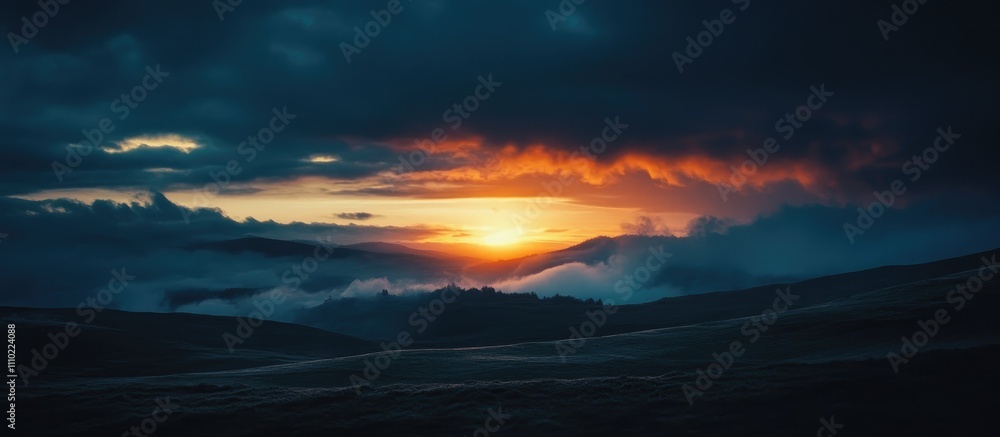 Fototapeta premium Majestic sunset over mountain ridges with dramatic clouds and vibrant colors illuminating the sky and valley below.
