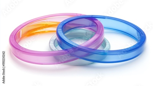 Colorful plastic bands overlapping on a clean white background showcasing vibrant hues of blue, pink, and orange for design and craft purposes