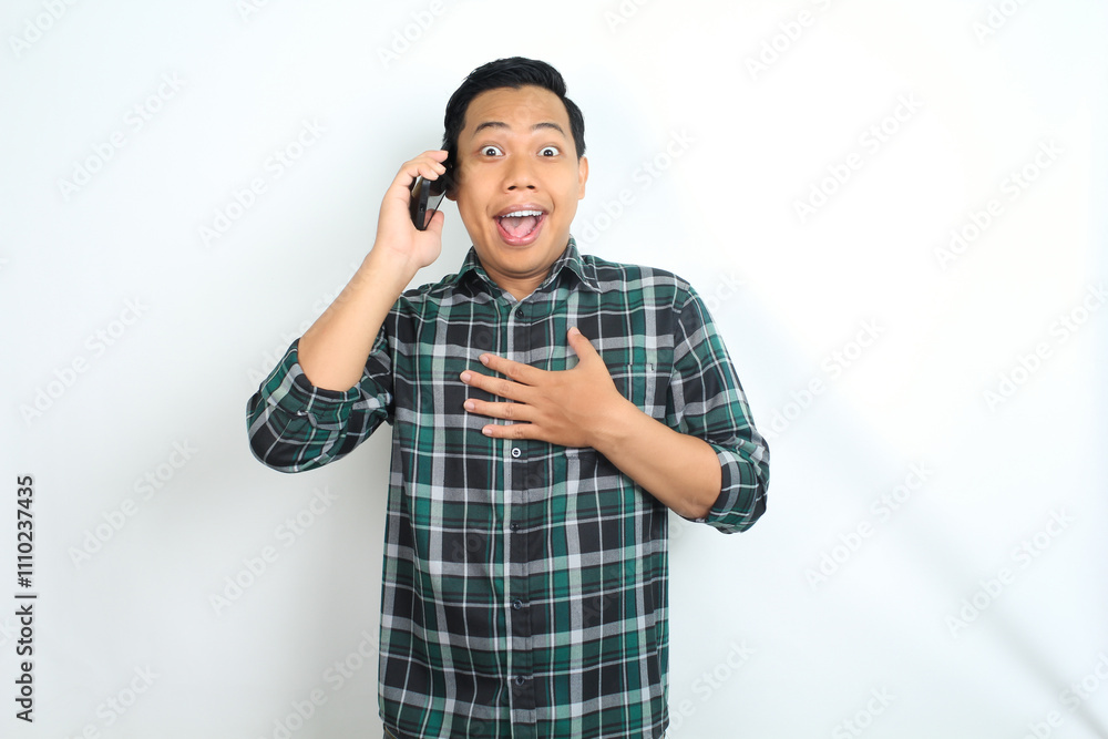 asian man surprised with touching chest while talking on smartphone isolated on white background, wearing casual green shirt asian man surprised with touching chest while talking on smartphone isolated on white background, wearing casual green shirt
