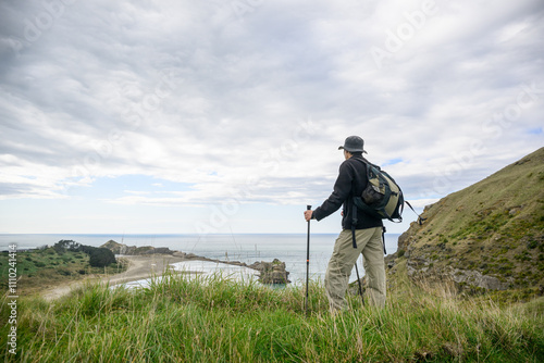 Obraz na płótnie Man hiking the Deliverance Cove track. Castlepoint. Wairarapa. New Zealand. w salonie