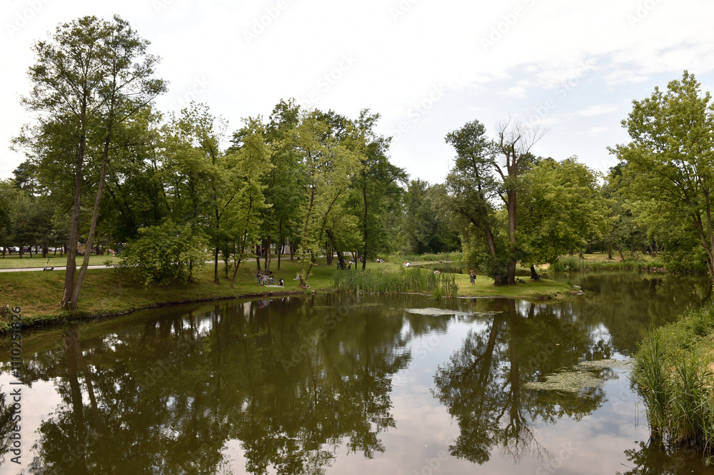 Scenic Summer Landscape with Calm River and Lush Greenery in Poland Scenic Summer Landscape with Calm River and Lush Greenery in Poland