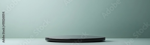 Matte grey podium with a sleek surface  set against a muted pastel green background  providing a spacious environment for product display.