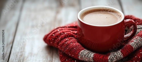 Cozy red cup of hot cacao on Scottish plaid fabric with wooden table backdrop and decorative beads ideal for holiday or winter-themed designs photo