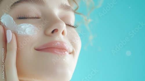 A woman with sensitive skin smiling and applying fragrance free moisturizer to her face, highlighting the product ability to hydrate without irritation or overpowering scents. photo