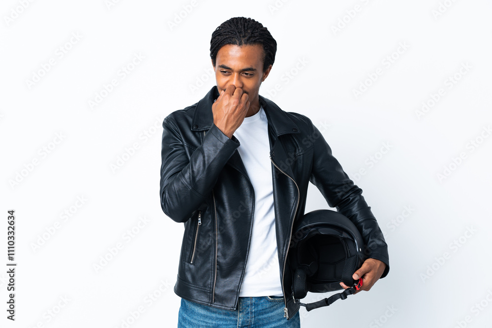 African American man with braids holding a motorcycle helmet isolated on white background having doubts African American man with braids holding a motorcycle helmet isolated on white background having doubts