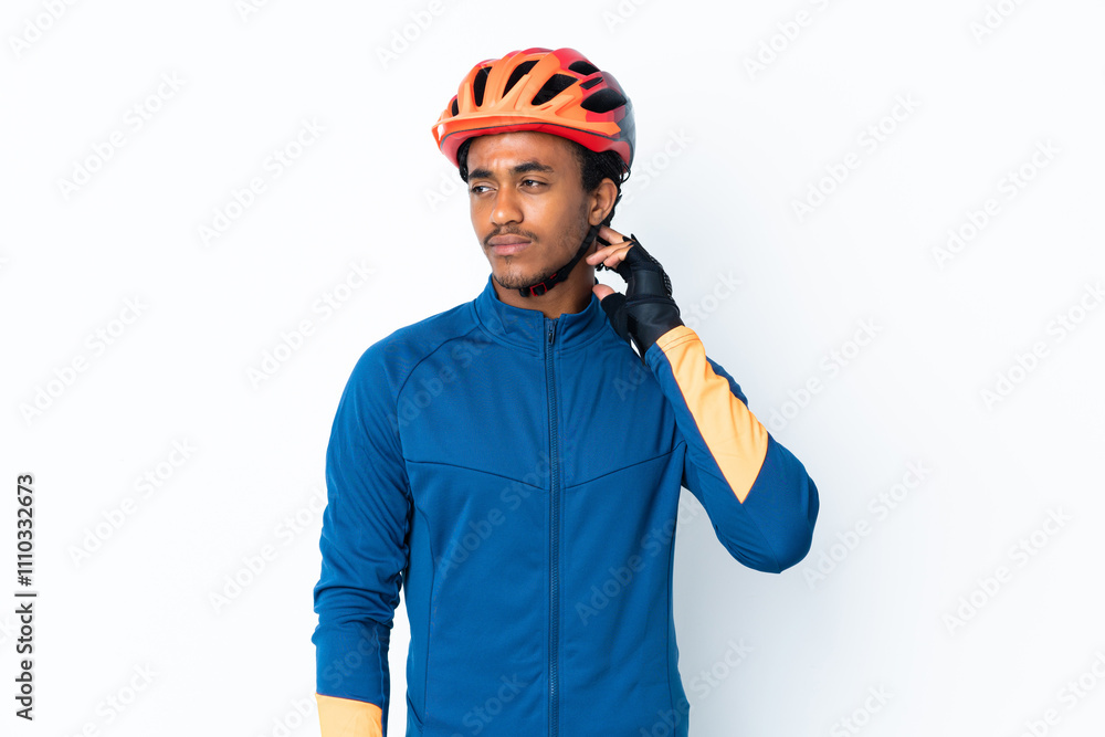 Young cyclist man with braids over isolated background having doubts Young cyclist man with braids over isolated background having doubts