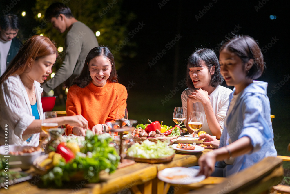 A group of women are sitting around a table eating and drinking A group of women are sitting around a table eating and drinking