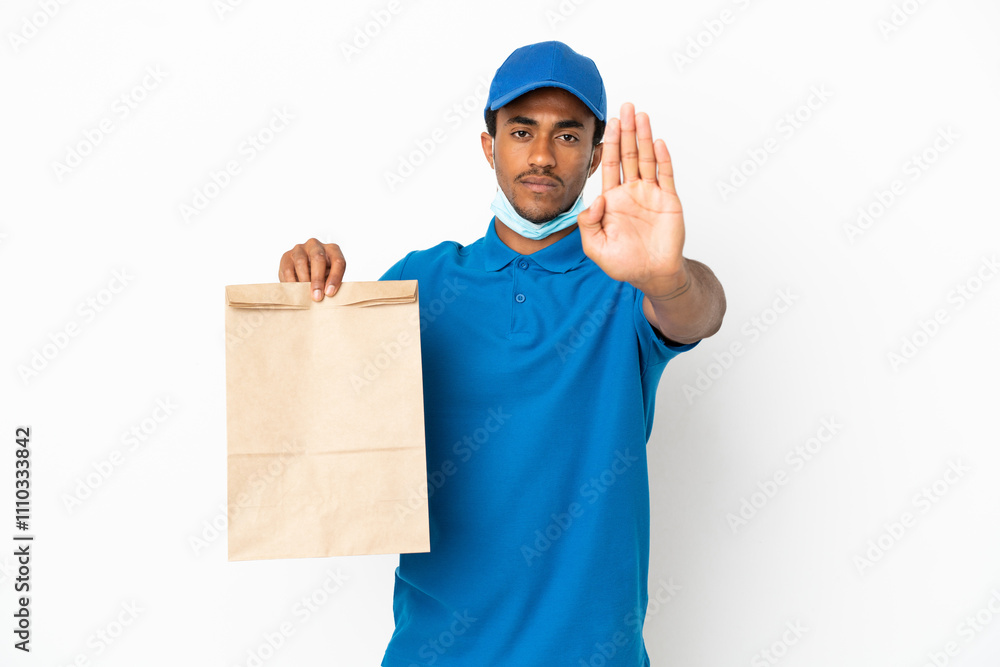 African American man taking a bag of takeaway food isolated on white background making stop gesture African American man taking a bag of takeaway food isolated on white background making stop gesture