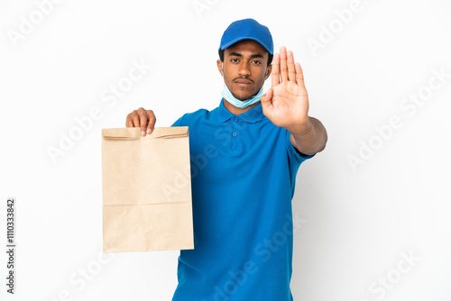 African American man taking a bag of takeaway food isolated on white background making stop gesture