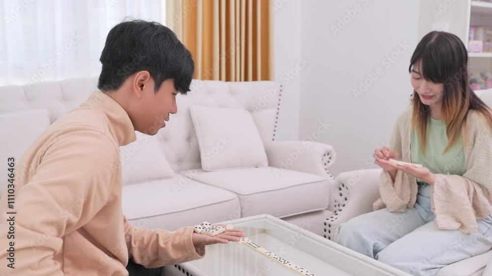 young asian couple lying on floor and playing dominoes at home,holidays,activity,relaxing,domestic life,recreation,entertainment young asian couple lying on floor and playing dominoes at home,holidays,activity,relaxing,domestic life,recreation,entertainment